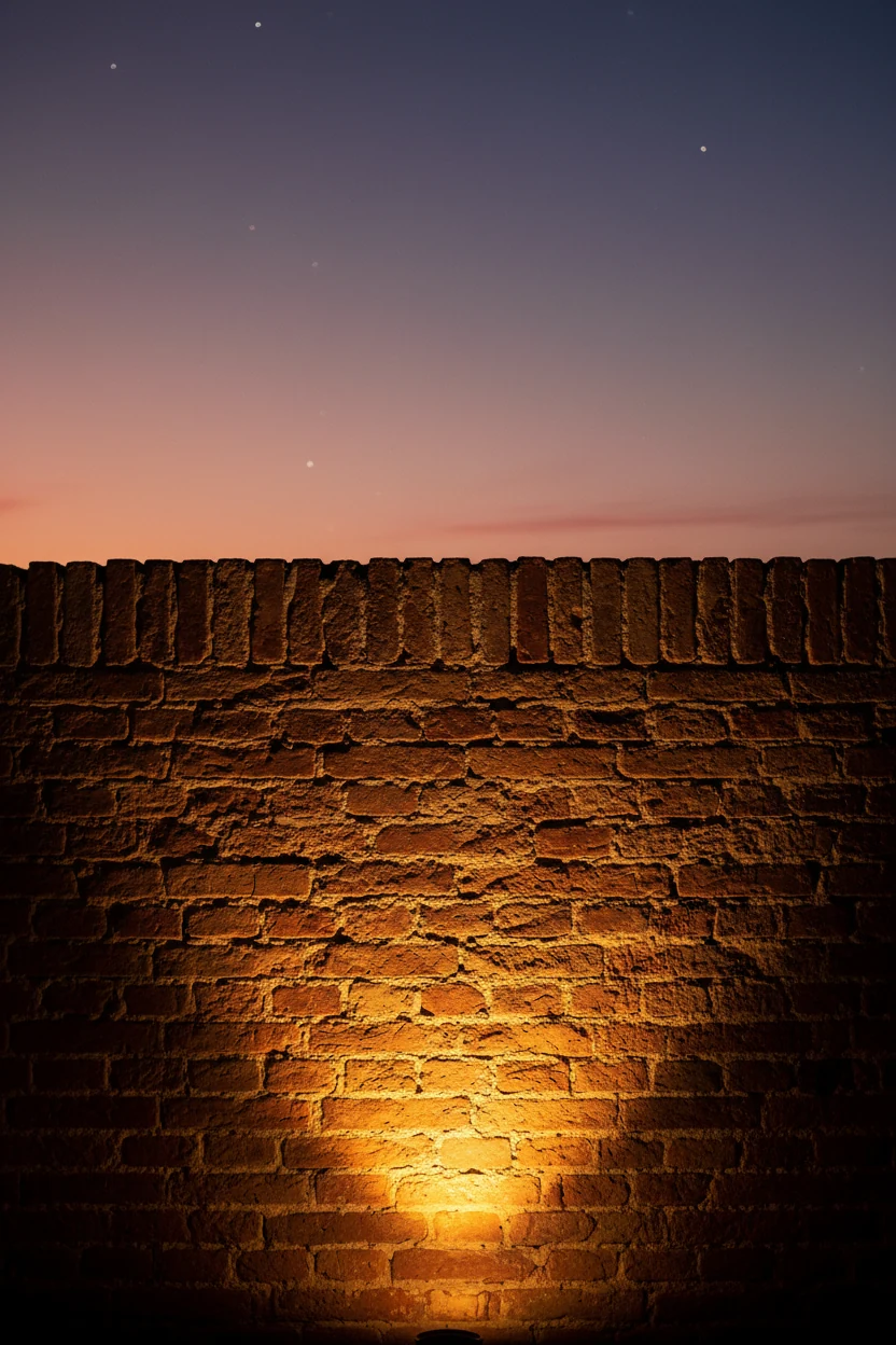 dusk closeup warm uplight grazing textured brick facade